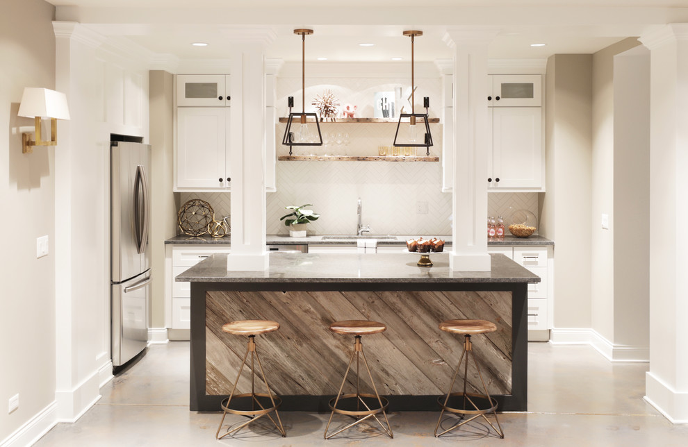This is an example of a mid-sized industrial l-shaped open plan kitchen in Chicago with a double-bowl sink, shaker cabinets, white cabinets, granite benchtops, white splashback, subway tile splashback, stainless steel appliances, cement tiles and with island.