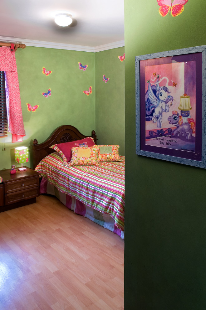 Inspiration for a mid-sized modern kids' room for girls in Other with green walls, light hardwood floors and brown floor.