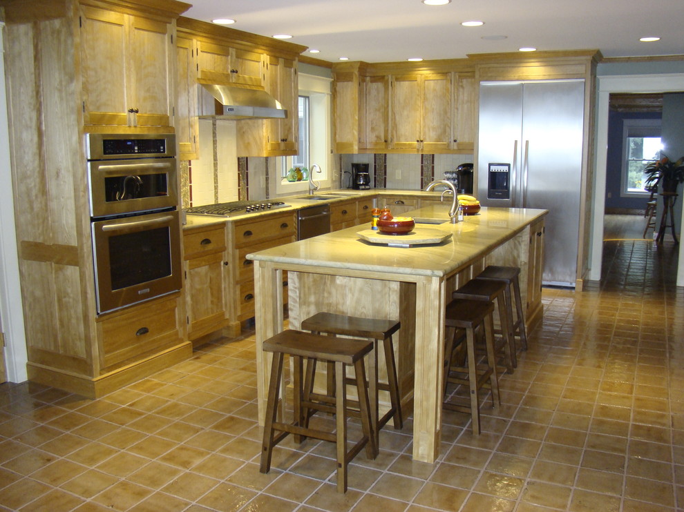 Mid-sized contemporary single-wall separate kitchen in Portland Maine with beaded inset cabinets, medium wood cabinets, granite benchtops, multi-coloured splashback, ceramic splashback, stainless steel appliances, with island, an undermount sink and ceramic floors.