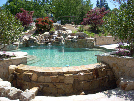 Example of a huge mountain style backyard custom-shaped natural hot tub design in San Francisco