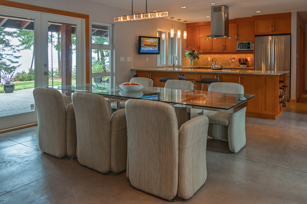 Photo of a mid-sized arts and crafts u-shaped kitchen in Vancouver with a single-bowl sink, shaker cabinets, light wood cabinets, granite benchtops, brown splashback, stone slab splashback, stainless steel appliances, cement tiles and a peninsula.