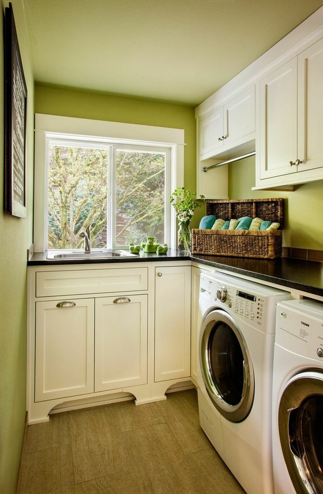 Inspiration for a small traditional l-shaped laundry room in Portland with a drop-in sink, shaker cabinets, white cabinets, green walls, a side-by-side washer and dryer, soapstone benchtops and ceramic floors.