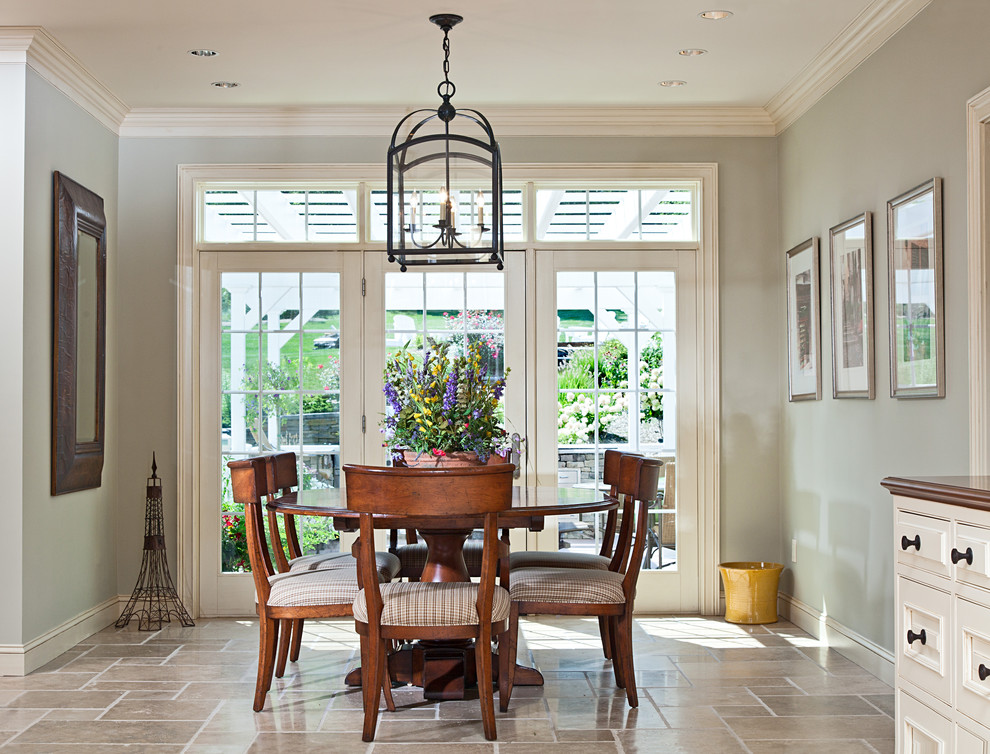 This is an example of a traditional dining room in Boston with grey walls and travertine floors.