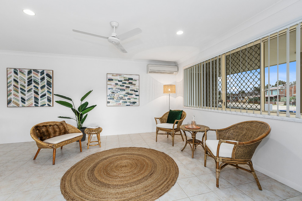 Beach style formal living room in Gold Coast - Tweed with white walls and beige floor.