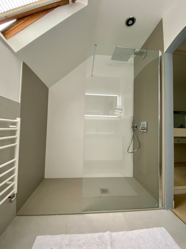This is an example of a small contemporary master bathroom in West Midlands with flat-panel cabinets, white cabinets, an open shower, a wall-mount toilet, gray tile, porcelain tile, white walls, porcelain floors, grey floor, an open shower, white benchtops, a single vanity and a floating vanity.