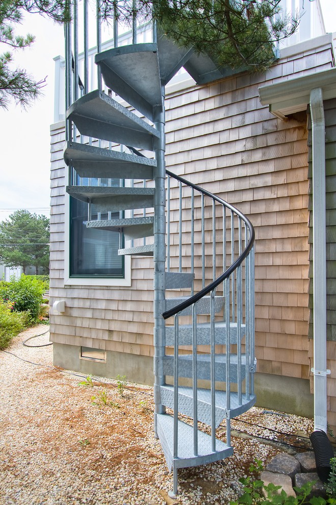 Design ideas for a small traditional metal spiral staircase in Philadelphia with metal risers.