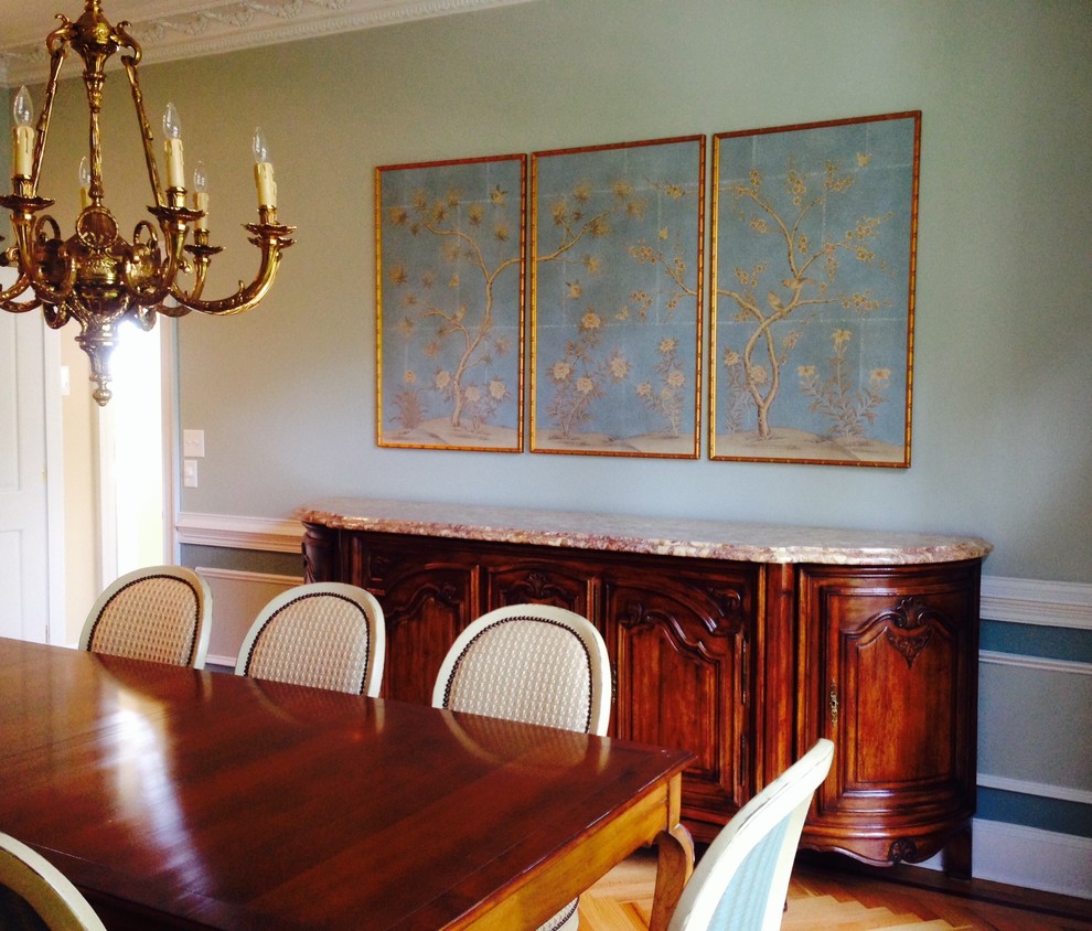 This is an example of a large traditional separate dining room in Chicago with blue walls, light hardwood floors and no fireplace.