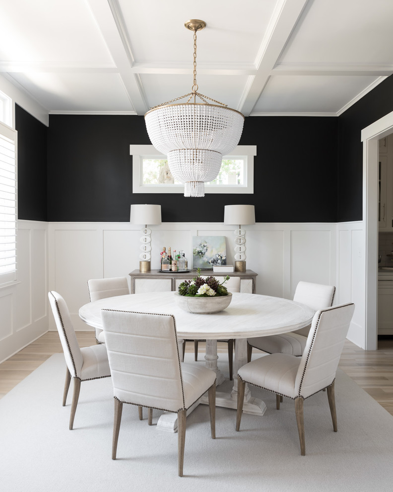 Design ideas for a transitional separate dining room in Charlotte with black walls, light hardwood floors and beige floor.