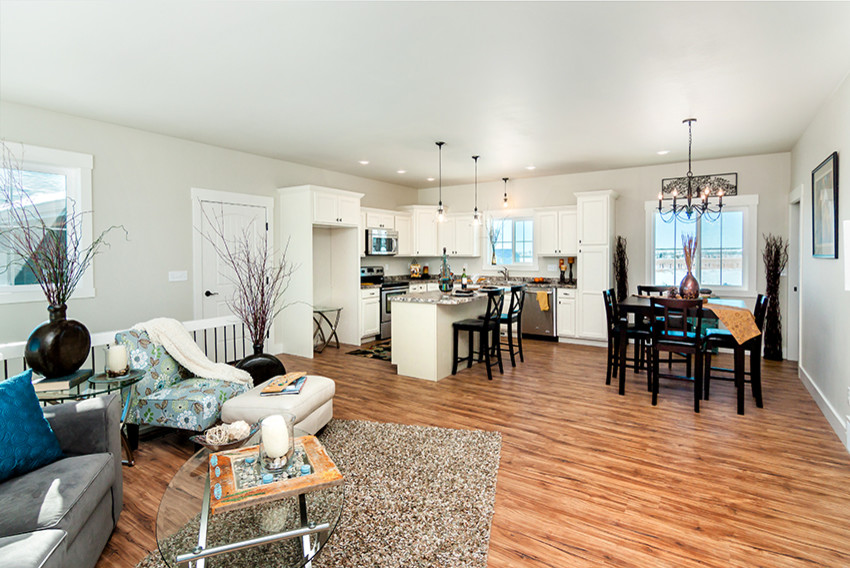 Inspiration for a mid-sized transitional l-shaped medium tone wood floor open concept kitchen remodel with an undermount sink, recessed-panel cabinets, white cabinets, granite countertops, stainless steel appliances and an island