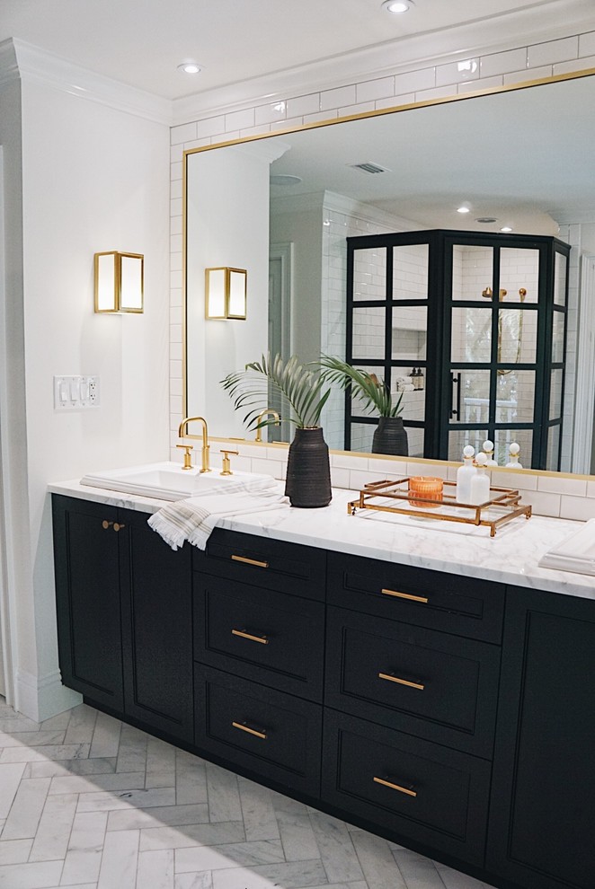 Large transitional master bathroom in Other with recessed-panel cabinets, black cabinets, a corner shower, white tile, ceramic tile, white walls, marble floors, a drop-in sink, marble benchtops, grey floor, a hinged shower door and white benchtops.