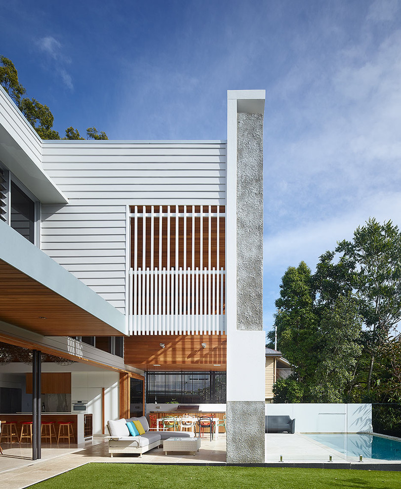 This is an example of a large contemporary two-storey white exterior in Brisbane.