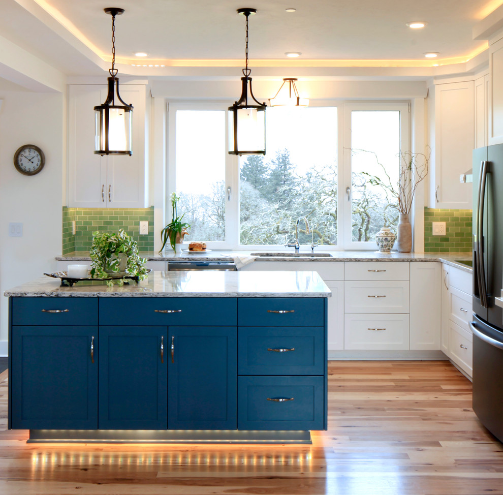 Inspiration for a mid-sized transitional l-shaped medium tone wood floor and beige floor eat-in kitchen remodel with an undermount sink, shaker cabinets, white cabinets, quartz countertops, green backsplash, subway tile backsplash, stainless steel appliances, an island and multicolored countertops