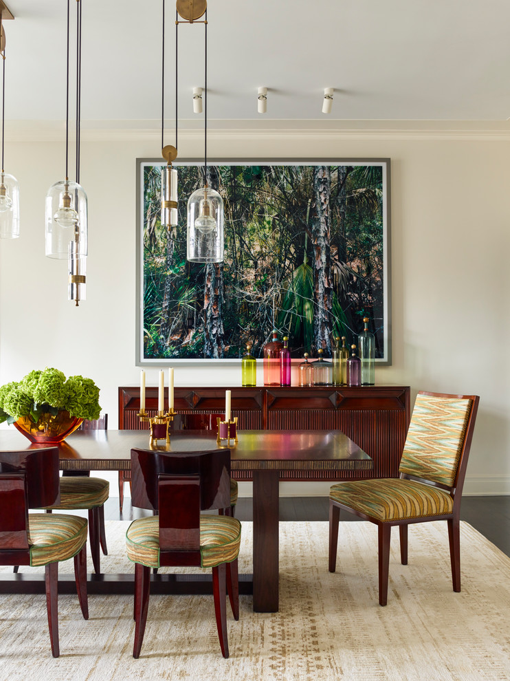 Transitional dining room in New York with beige walls, dark hardwood floors and brown floor.