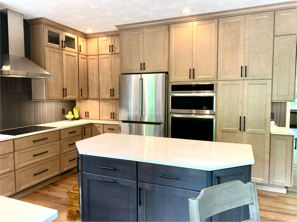 Example of a transitional u-shaped vinyl floor and brown floor eat-in kitchen design in Grand Rapids with an undermount sink, shaker cabinets, medium tone wood cabinets, quartzite countertops, black backsplash, porcelain backsplash, stainless steel appliances, an island and white countertops