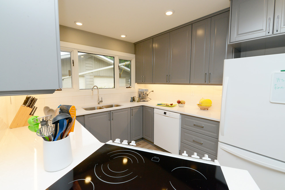 Inspiration for a small timeless u-shaped light wood floor and beige floor enclosed kitchen remodel with a double-bowl sink, raised-panel cabinets, gray cabinets, quartz countertops, white appliances, no island and white countertops