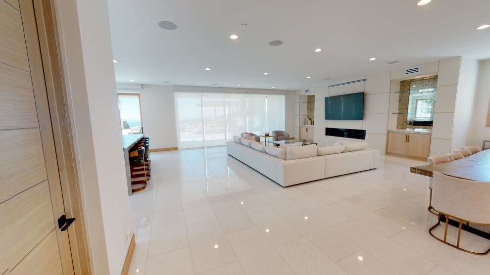 Example of a huge trendy open concept porcelain tile and white floor family room design in Orange County with white walls