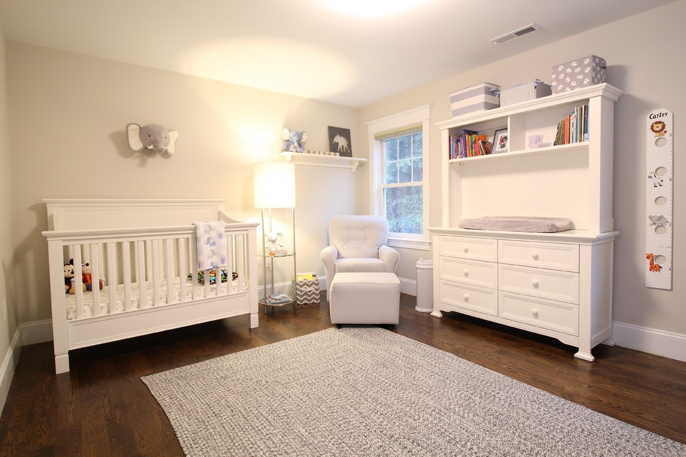 Example of a large transitional guest dark wood floor and brown floor nursery design in Boston with gray walls