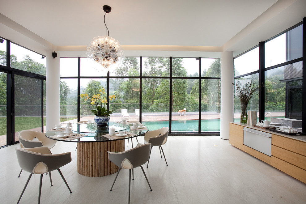 This is an example of a contemporary dining room in Hong Kong with light hardwood floors.