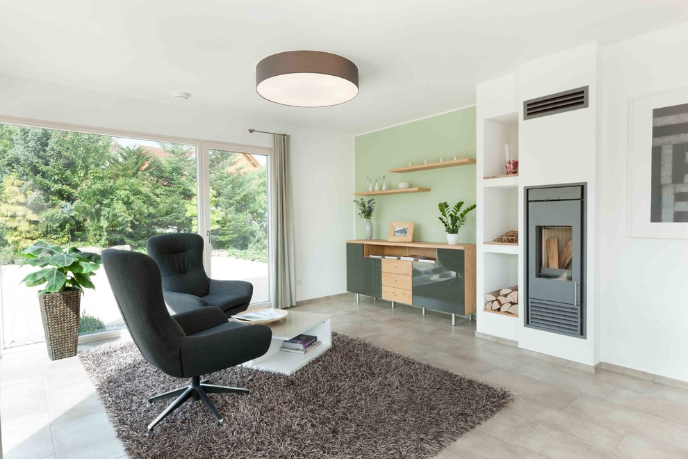 Inspiration for a mid-sized contemporary open concept family room in Stuttgart with green walls, ceramic floors, a wood stove, a plaster fireplace surround, no tv and beige floor.