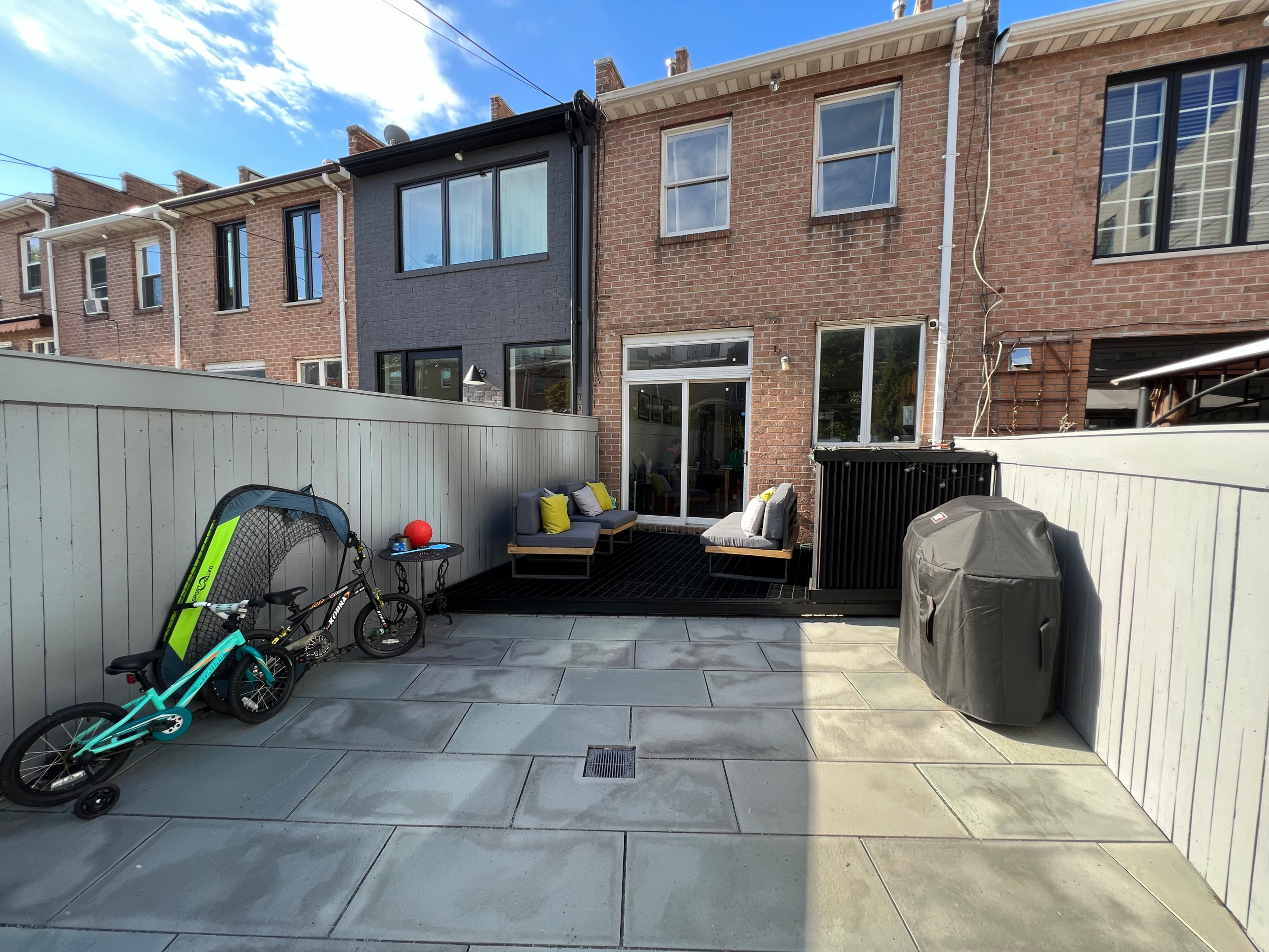 Paved patio with metal grating garden