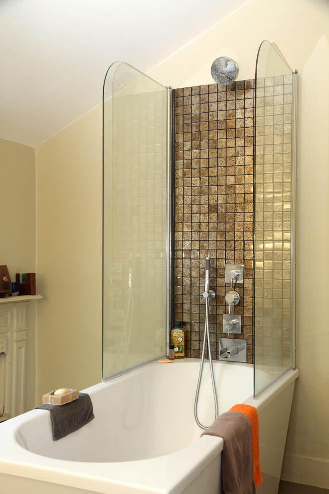 Photo of a mid-sized eclectic master bathroom in London with a freestanding tub, a shower/bathtub combo, brown tile, mosaic tile and beige walls.