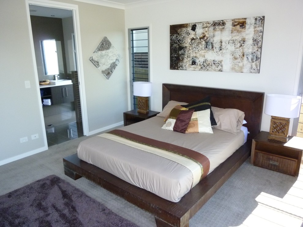 Mid-sized asian master bedroom in Sunshine Coast with carpet.