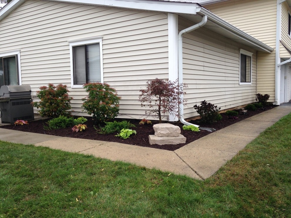 Inspiration for a large transitional full sun side yard stone formal garden in Chicago.