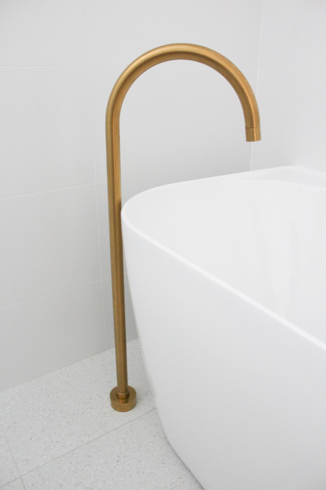 This is an example of a mid-sized modern master wet room bathroom in Perth with flat-panel cabinets, light wood cabinets, a freestanding tub, white tile, ceramic tile, white walls, porcelain floors, a vessel sink, engineered quartz benchtops, grey floor, an open shower, white benchtops, a single vanity and a floating vanity.