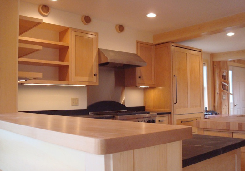 Inspiration for a mid-sized l-shaped medium tone wood floor eat-in kitchen remodel with medium tone wood cabinets, solid surface countertops, stainless steel appliances and an island