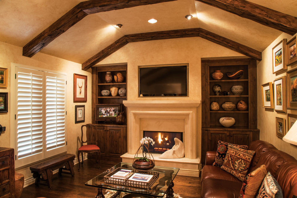 Design ideas for a mid-sized traditional family room in Wichita with beige walls, medium hardwood floors, a standard fireplace, a concrete fireplace surround and a wall-mounted tv.