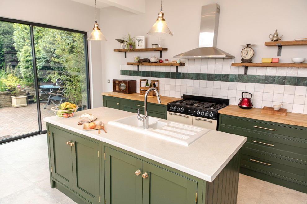 Inspiration for a large traditional eat-in kitchen in Dorset with shaker cabinets, green cabinets, wood benchtops, with island and brown benchtop.