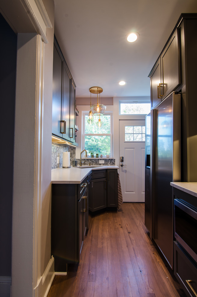 Photo of a contemporary galley eat-in kitchen in DC Metro with an undermount sink, shaker cabinets, grey cabinets, quartz benchtops, multi-coloured splashback, mosaic tile splashback, stainless steel appliances, light hardwood floors, brown floor and multi-coloured benchtop.