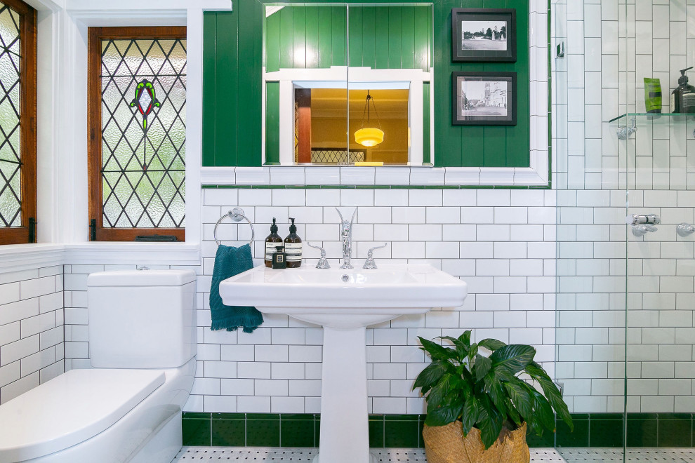 This is an example of a traditional bathroom in Brisbane with an alcove shower, white tile, subway tile, mosaic tile floors, a pedestal sink, grey floor and a single vanity.