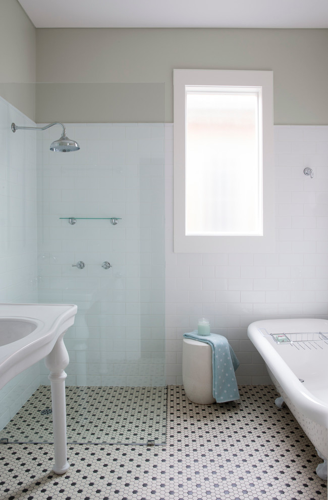 Inspiration for a transitional bathroom in Sydney with a claw-foot tub, a console sink and subway tile.