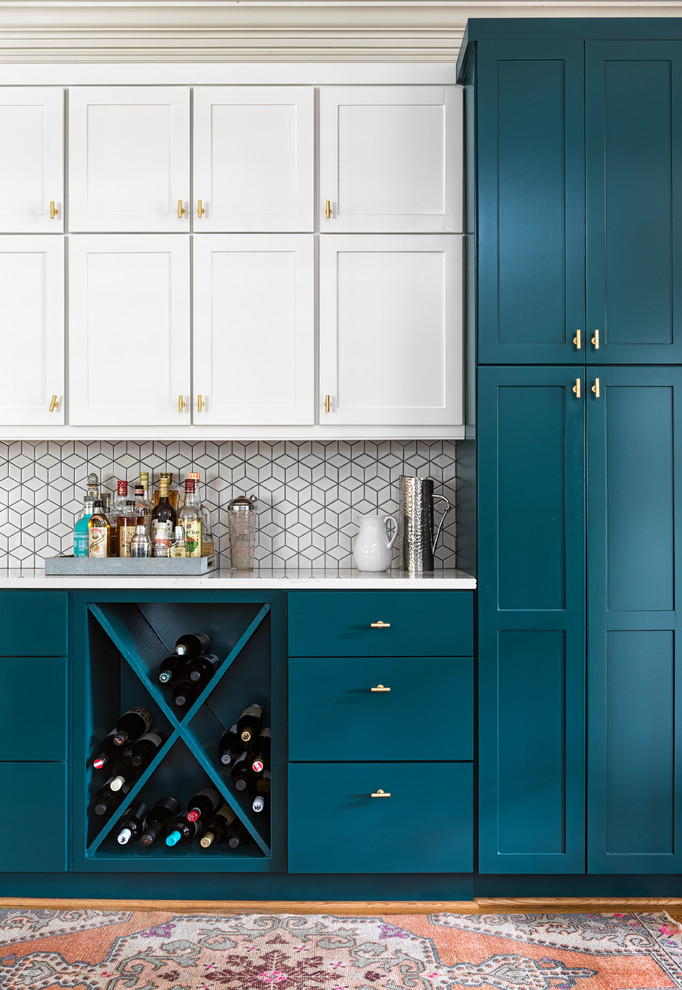 Photo of a modern kitchen in Atlanta with recessed-panel cabinets, turquoise cabinets, white splashback, ceramic splashback, light hardwood floors and white benchtop.