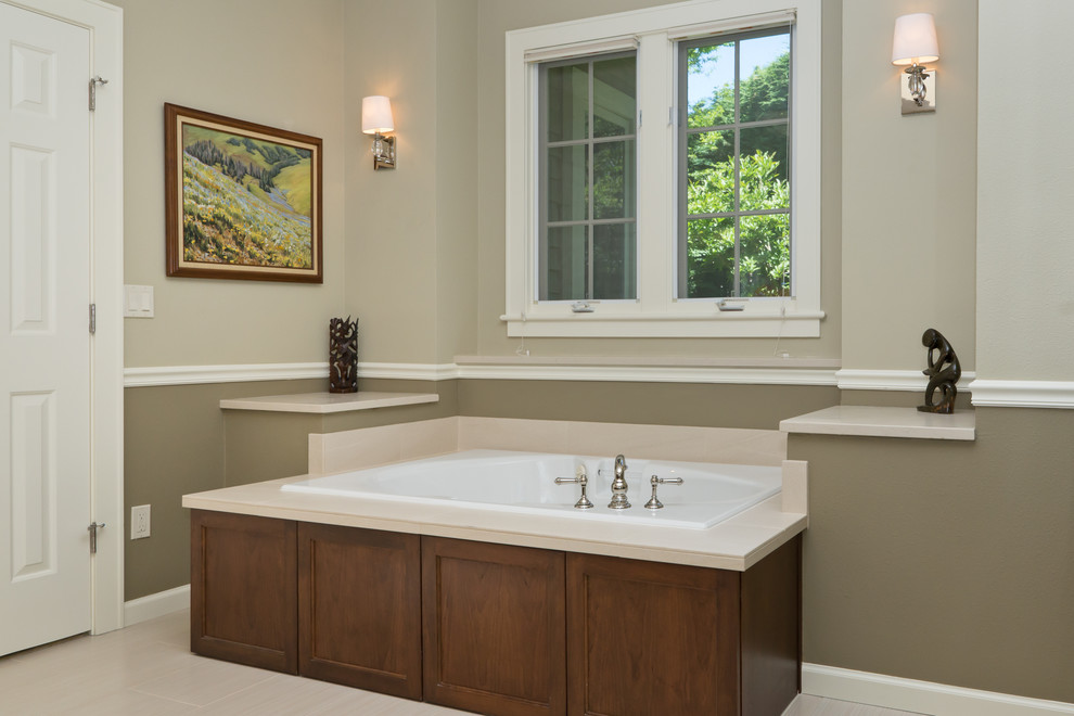Inspiration for a large transitional master bathroom in Portland with recessed-panel cabinets, dark wood cabinets, engineered quartz benchtops, a drop-in tub, beige tile, porcelain tile, a curbless shower, a one-piece toilet, an undermount sink, multi-coloured walls and porcelain floors.