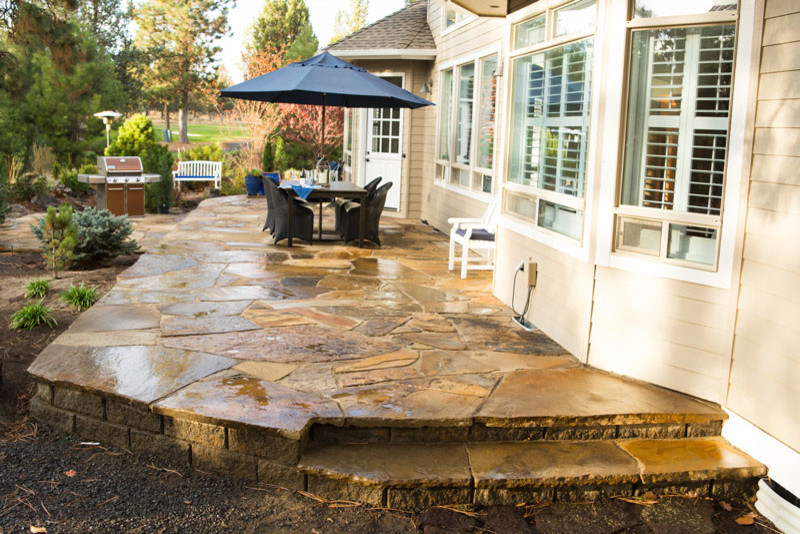 Design ideas for a large arts and crafts backyard patio in Portland with natural stone pavers and no cover.