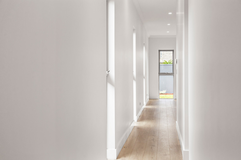 Photo of a mid-sized hallway in Adelaide with grey walls, laminate floors and grey floor.