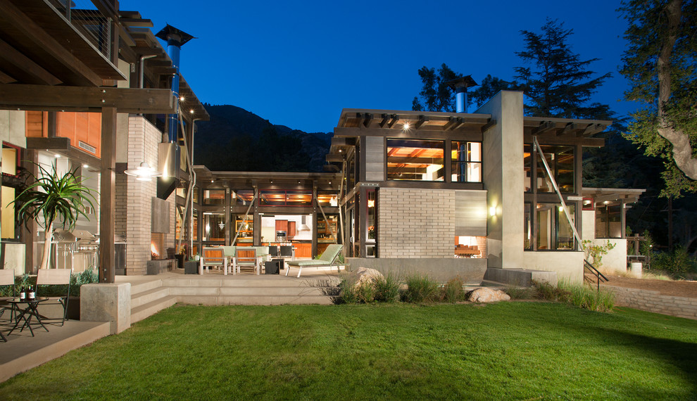 Large trendy backyard concrete patio photo in Los Angeles with a fire pit and no cover