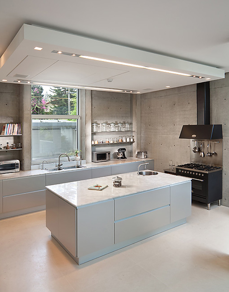 Kitchen - industrial kitchen idea in Other with a double-bowl sink, flat-panel cabinets, blue cabinets and black appliances
