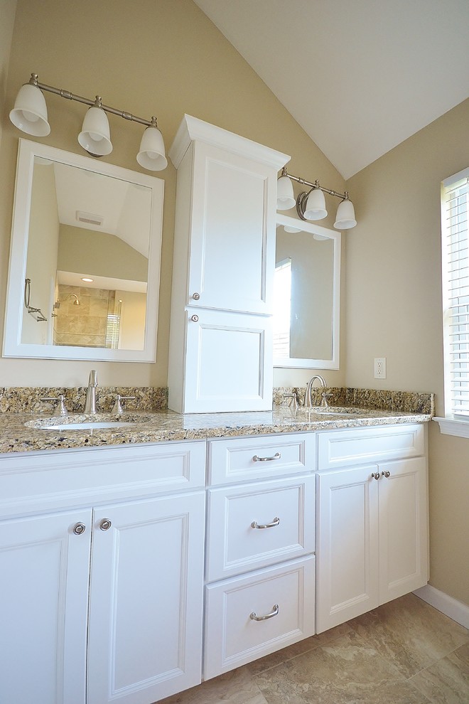 Large transitional master bathroom in Philadelphia with an undermount sink, flat-panel cabinets, white cabinets, granite benchtops, a freestanding tub, a corner shower, a one-piece toilet, beige tile, ceramic tile, beige walls and ceramic floors.