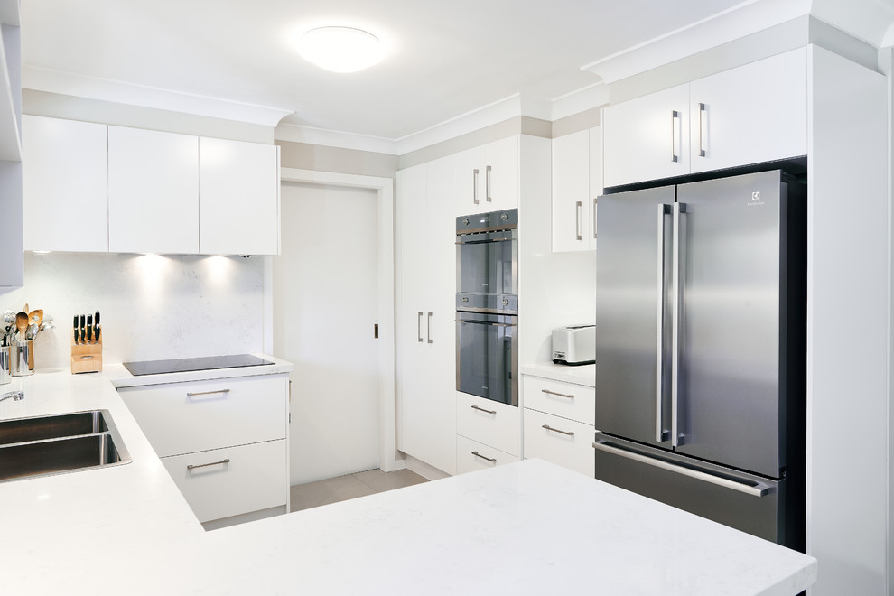 Design ideas for a small contemporary u-shaped separate kitchen in Sydney with a double-bowl sink, flat-panel cabinets, white cabinets, laminate benchtops, stainless steel appliances and ceramic floors.