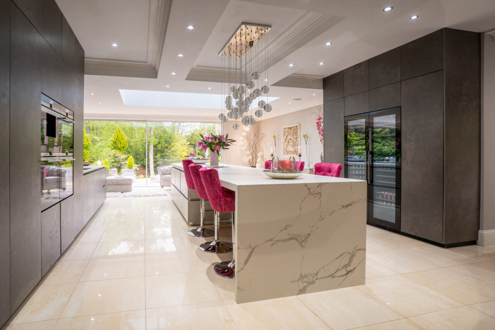 Photo of a large contemporary open plan kitchen in Berkshire with an integrated sink, flat-panel cabinets, panelled appliances and with island.