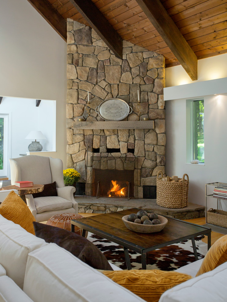 Inspiration for a mid-sized country living room in Boston with a corner fireplace and white walls.