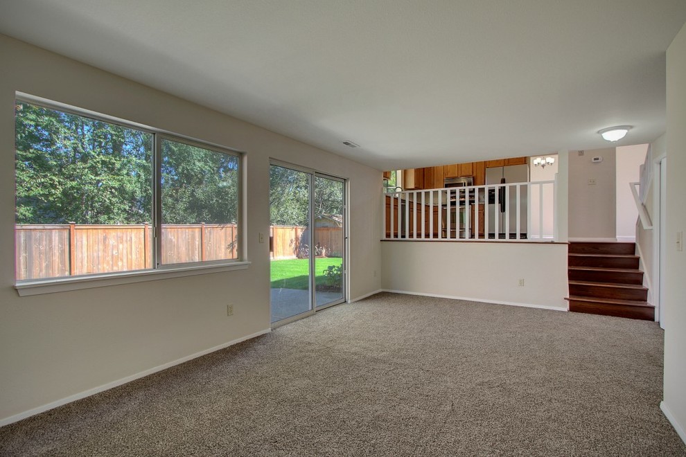 Design ideas for a mid-sized traditional walk-out basement in Seattle with beige walls and carpet.