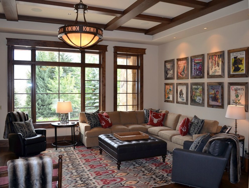 Inspiration for a transitional enclosed family room in Denver with beige walls and dark hardwood floors.