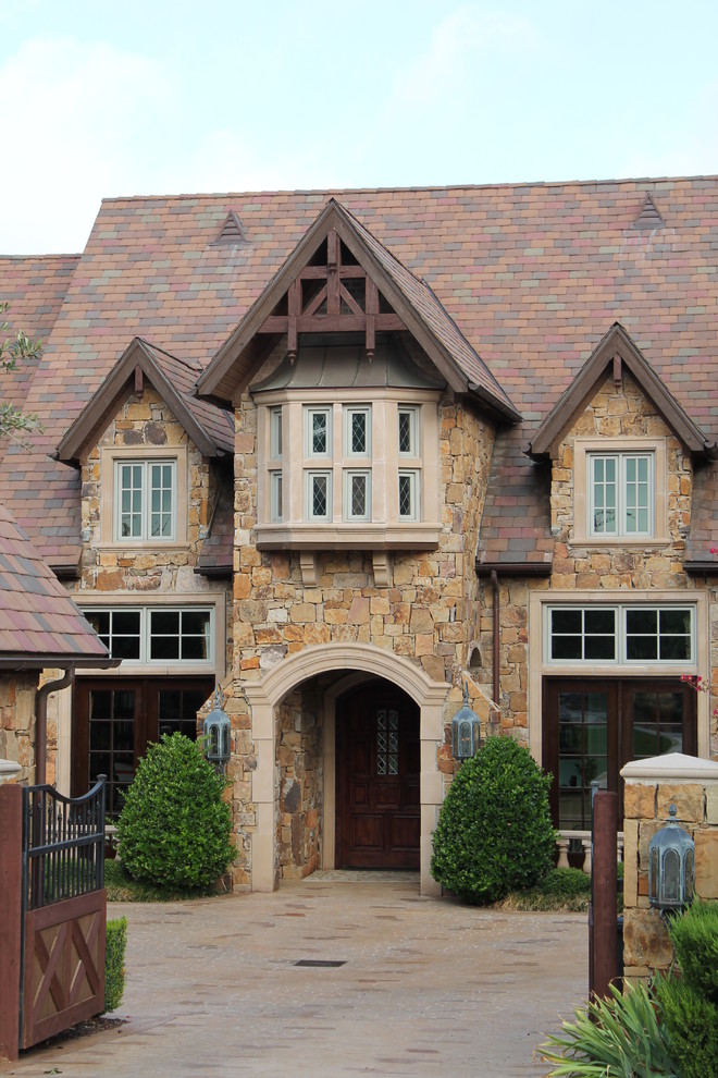 Example of a classic stone exterior home design in Dallas