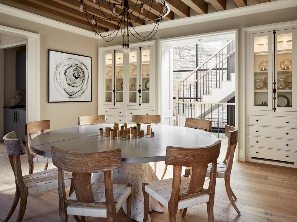 Photo of a transitional dining room in Chicago with beige walls, light hardwood floors and brown floor.
