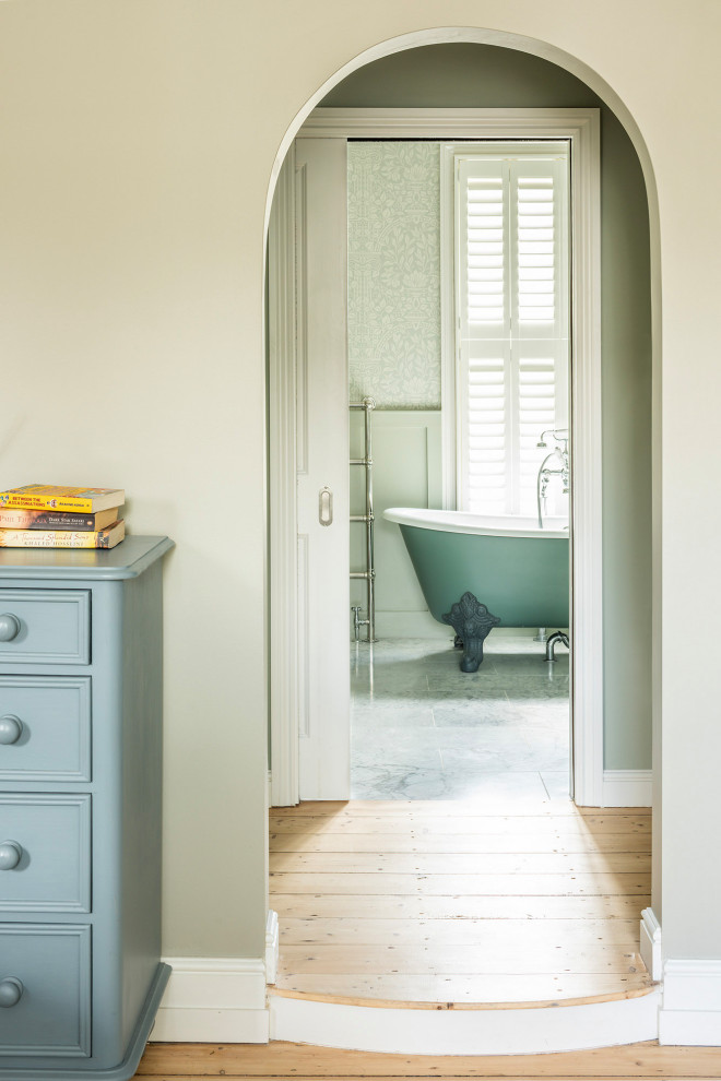 Inspiration for a large contemporary kids bathroom in London with recessed-panel cabinets, green cabinets, a claw-foot tub, a one-piece toilet, green walls, limestone floors, marble benchtops, white benchtops, a double vanity, a built-in vanity and wallpaper.