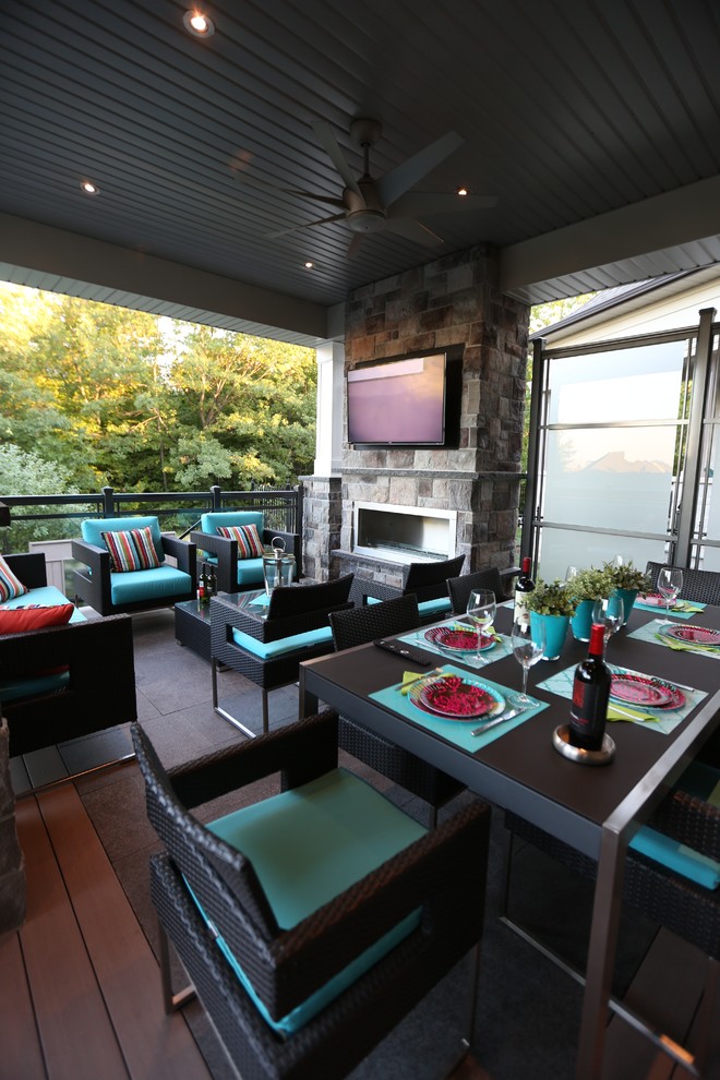 Transitional backyard deck photo in Toronto with a roof extension